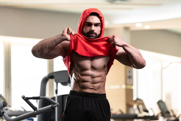 Young Man Standing Strong Gym Flexing Muscles Red Hoodie Muscular — Stockfoto
