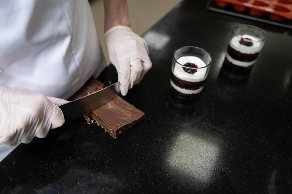 Chocolate Chef is Using Knife Chop Dark Chocolate Bars to Into Small for Preparing to Make Chocolate Beverage