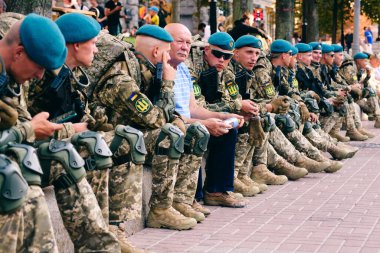 Kyiv, Ukraine - August 20, 2021: Rehearsal of military parade on occasion of 30 years Independence Day of Ukraine. Ukrainian young military men in uniform resting between training sessions