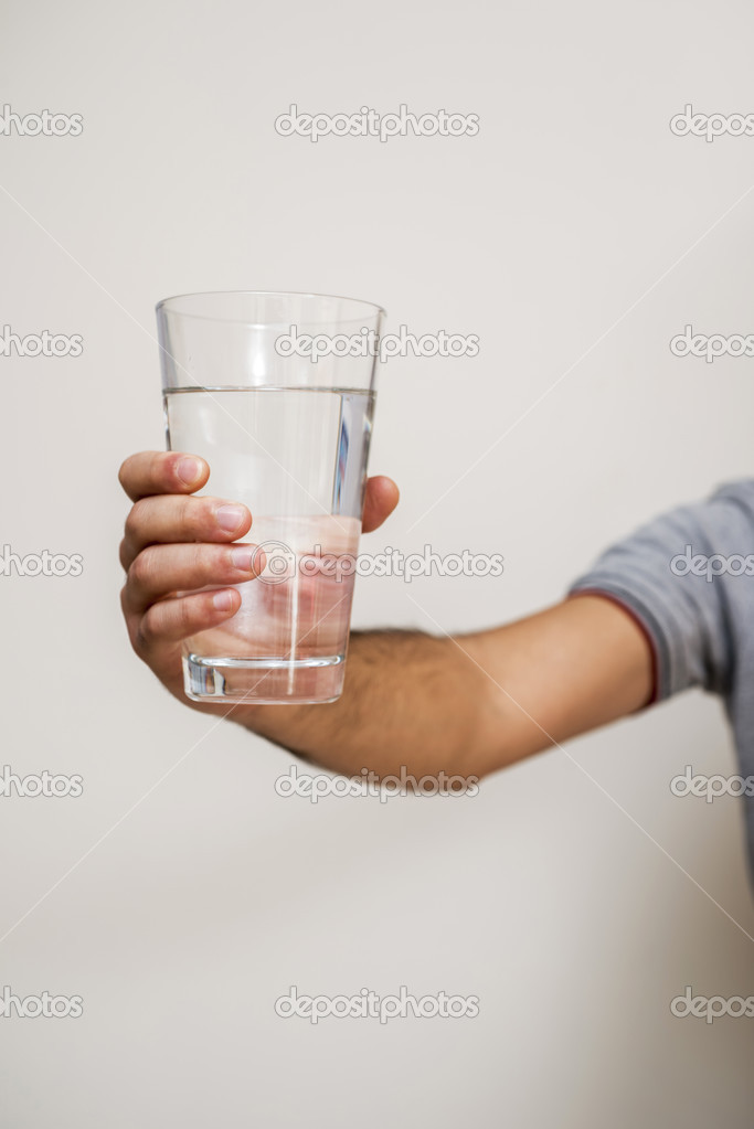 Hand holding a glass of water Stock Photo by ©kokal 47299659