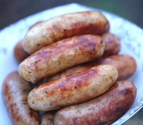 Pork sausages barbecued on the plate — Stock Photo, Image