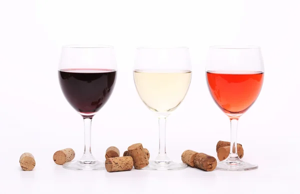 Three wine glasses and corks. — Stock Photo, Image