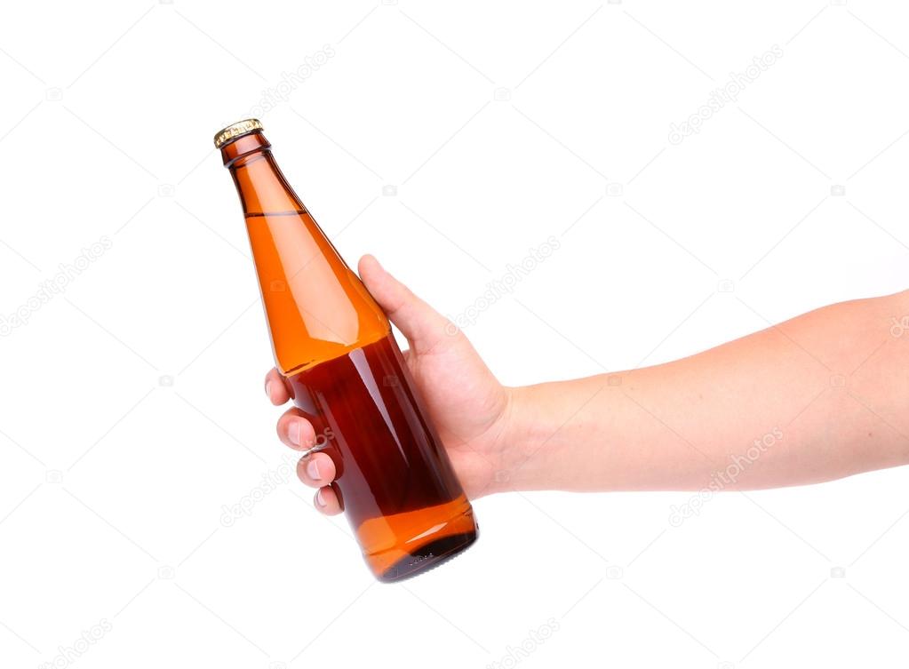 A hand holding up a yellow beer bottle