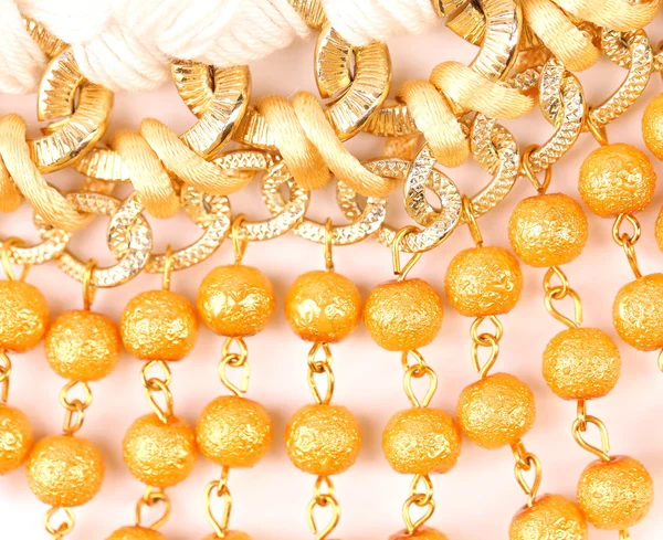 Golden pearls with macrame — Stock Photo, Image
