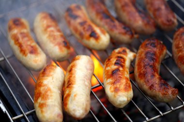 Nicely grilled sausages on a whole background clipart