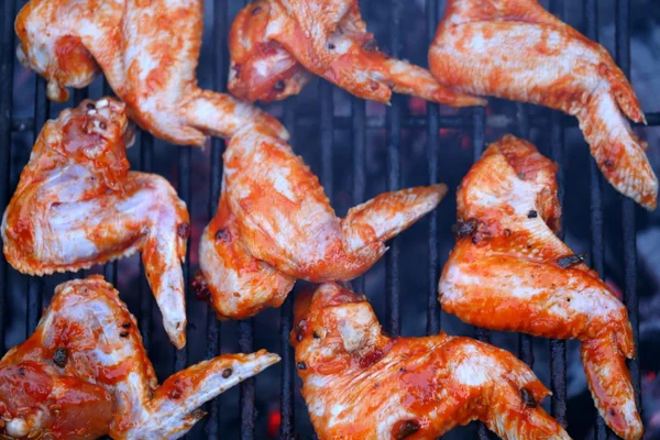 Chicken wings on smoking grill in the garden — Stock Photo, Image
