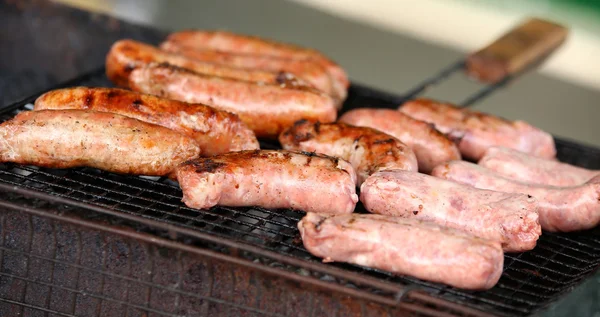 Fresh sausage and hot dogs grilling. — Stock Photo, Image