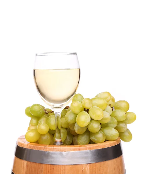 Ripe grapes and wine glass on a wooden barrel — Stock Photo, Image