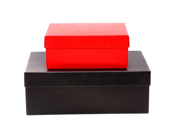 Две коробки, красная и черная на белом фоне — стоковое фото