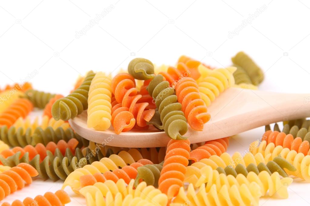 Colorful pasta with wooden spoon.