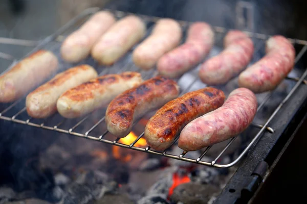 Sausages on grill. A whole background — Stock Photo, Image
