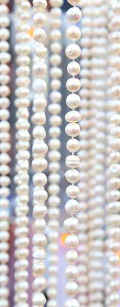 Many beads of pearls as ackground. Close-up. — Stock Photo, Image