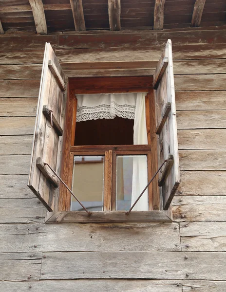 Window of a old wooden house with shutters — Stock Photo, Image