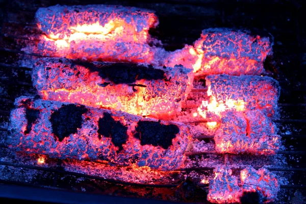 Glowing embers from wooden briquettes. — Stock Photo, Image