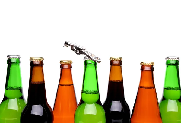 Top bottles of beer and a opener. — Stock Photo, Image