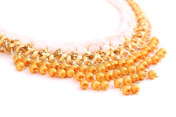Necklace of gold pearls on a white bacground — Stock Photo, Image