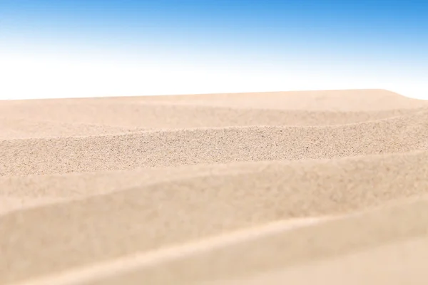 Sand dunes on a blue sky background — Stock Photo, Image