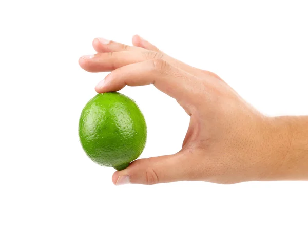 Bilden av grön lime i hand — Stockfoto