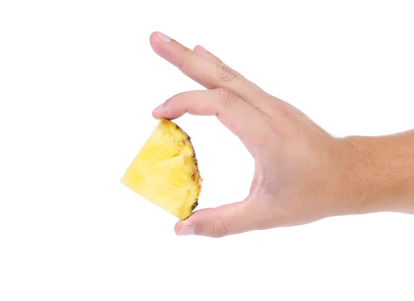 Piece of pineapple in hand on a white background — Stock Photo, Image