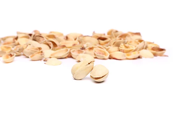 Two pistachios and peel on the white background. — Stock Photo, Image