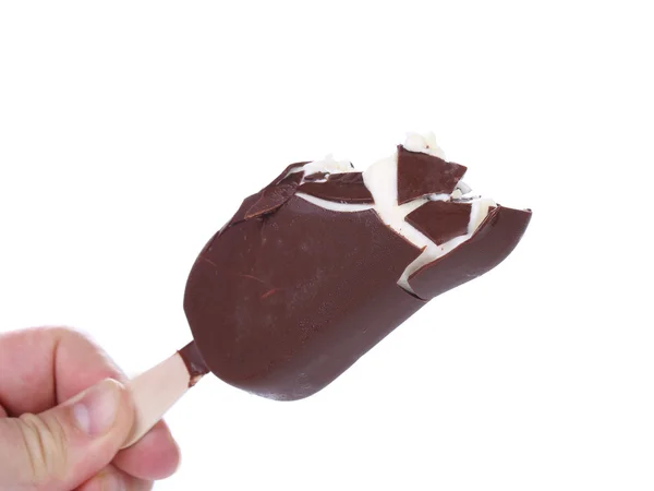 Hand holds bitten chocolate vanilla ice cream. — Stock Photo, Image