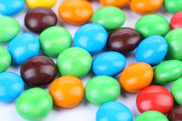 Backgroynd of chocolate balls in colorful glaze. — Stock Photo, Image