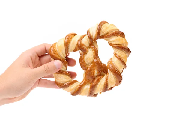 Hand holds freshly fancy pretzel baked. — Stock Photo, Image