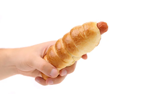 Hand holds hot dog baked. — Stock Photo, Image