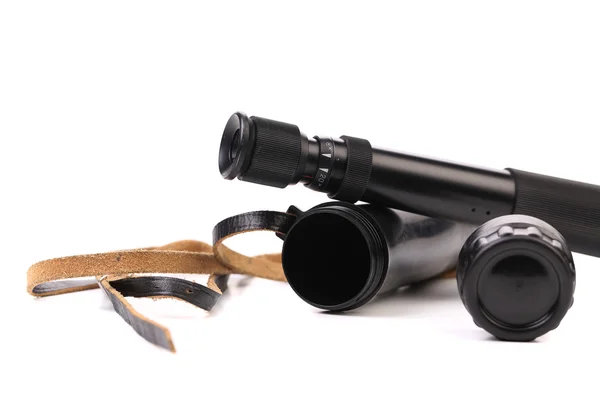 Black cover and spyglass lying — Stock Photo, Image