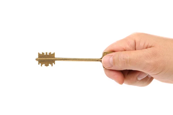 Hand holds bronze steel key. — Stock Photo, Image