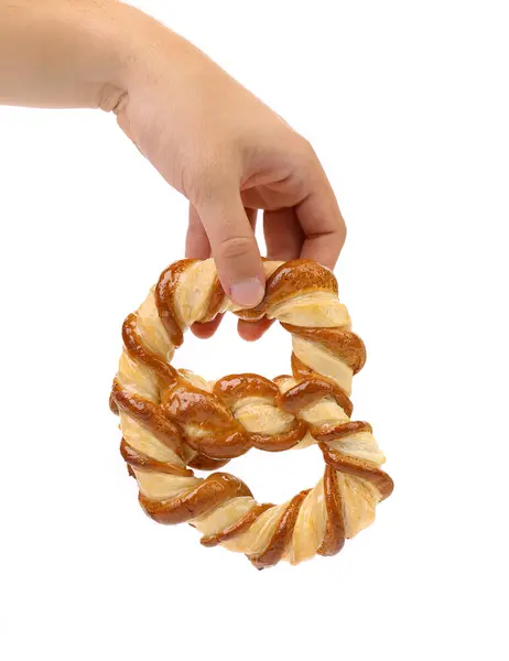 Hand holds freshly fancy pretzel baked. — Stock Photo, Image