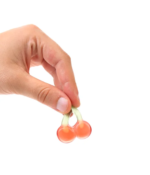 Hand holds fruit jelly in form of cherries. — Stock Photo, Image