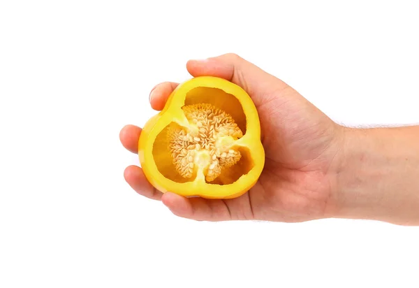 Hand holds half of yellow pepper. — Stock Photo, Image