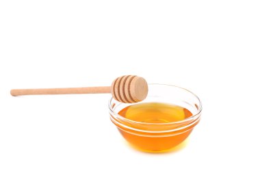 Wooden spoon on bowl with honey. clipart