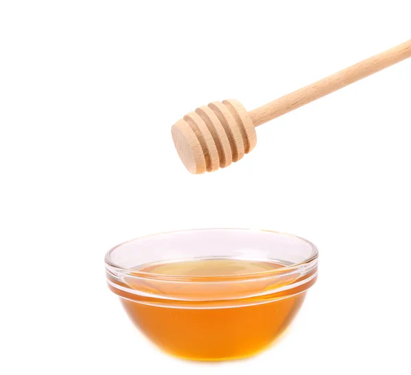 Bow of honey and wooden spoon. — Stock Photo, Image