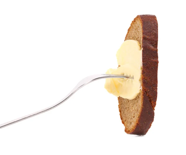 Brown bread and butter on a fork. — Stock Photo, Image