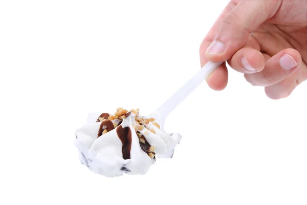 Hand holds ice cream on a spoon. — Stock Photo, Image