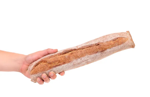 Hand holds long loaf — Stock Photo, Image