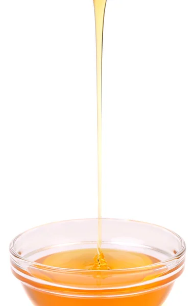 Honey poors into the bowl. — Stock Photo, Image