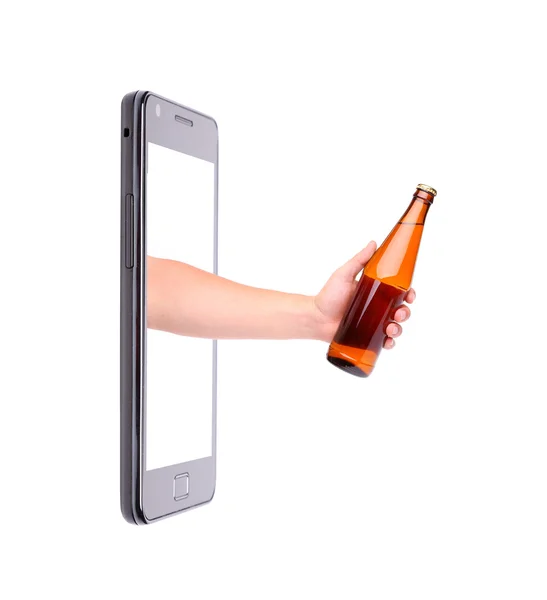 Hand with bottle of beer climbs from phone. — Stock Photo, Image