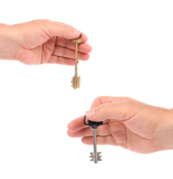 Hands holds modern steel-plastic and bronze key. — Stock Photo, Image