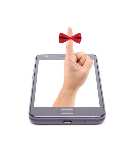 Hand and red tie bow gets out of phone. — Stock Photo, Image