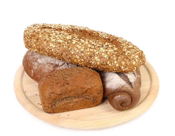 Shot of assorted bread in a wooden tray — Stock Photo, Image