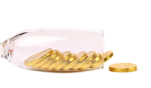 Chocolate coins get out of wineglass. — Stock Photo, Image