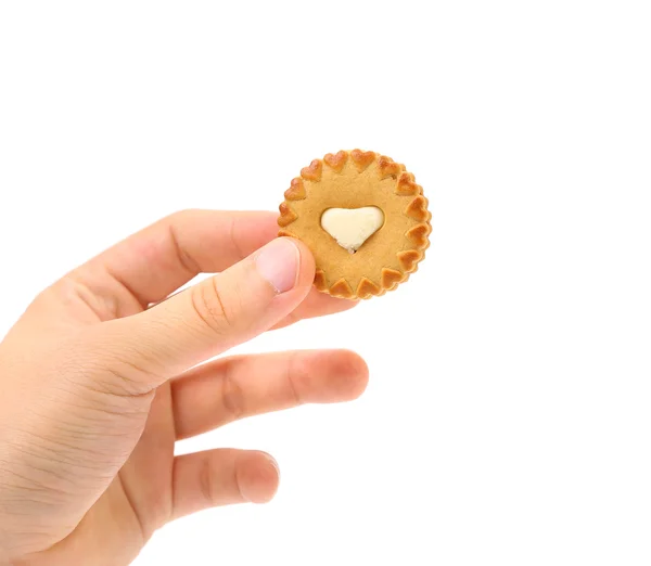 Hand holds biscuits with white heart. — Stock Photo, Image