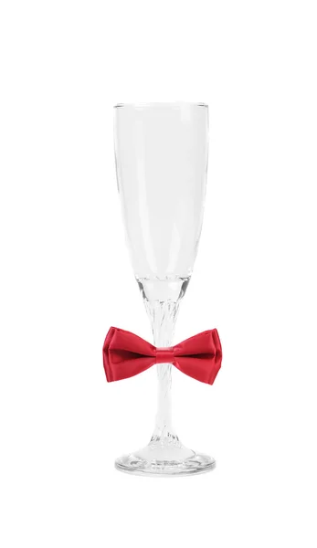 Tall wineglass and red bow tie. — Stock Photo, Image