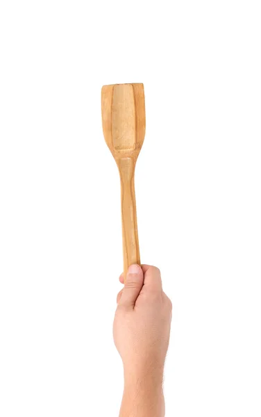 Hand holds woodfen spatula. — Stock Photo, Image