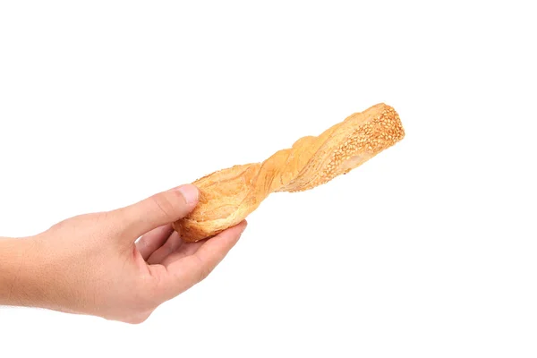 Hand holds crunchy puff pastry with sesame. — Stock Photo, Image