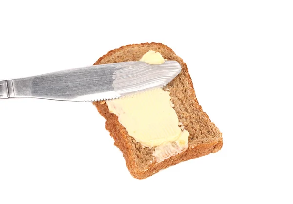 Smear butter on bread the knife. — Stock Photo, Image