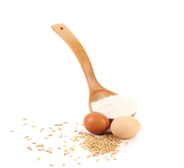 Wood spoon with eggs and grains. — Stock Photo, Image